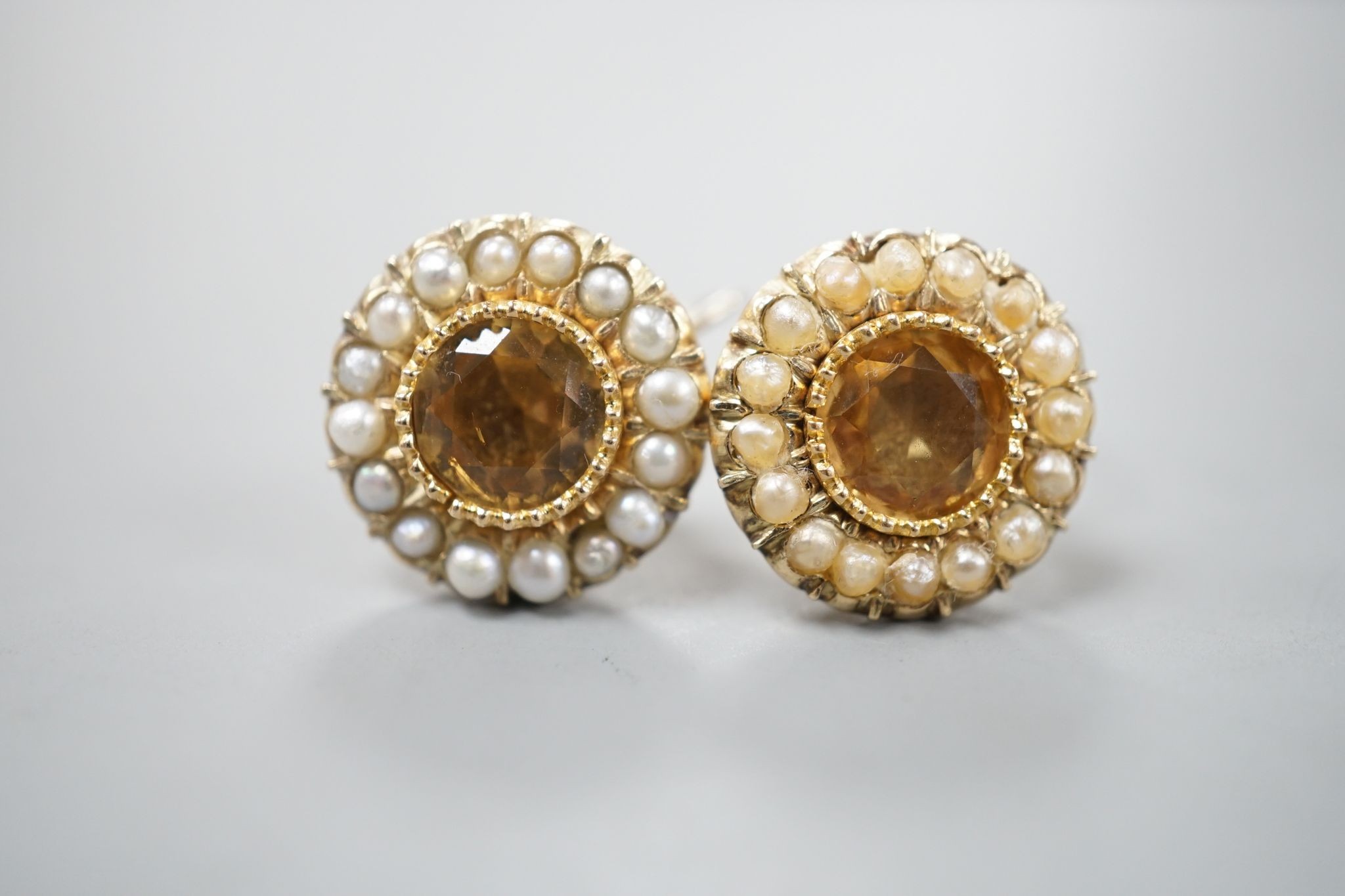 A pair of yellow metal, yellow topaz and split pearl set ear clips(adapted?), 14mm, gross 5.8 grams.